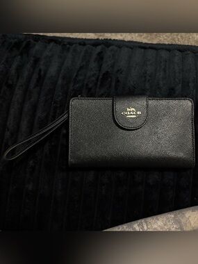 Coach black leather phone wallet with wrist strap